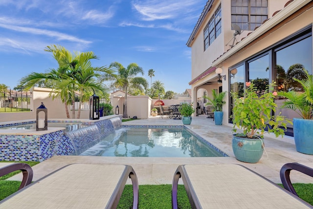 view of swimming pool with a patio area, an in ground hot tub, and pool water feature