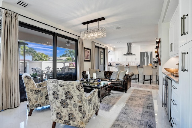 living room featuring ceiling fan and beverage cooler