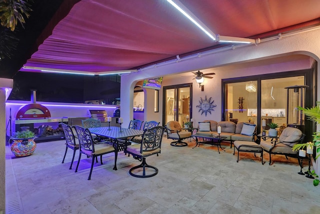 view of patio / terrace with ceiling fan and an outdoor living space