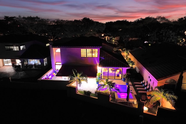 view of back house at dusk