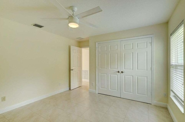 unfurnished bedroom with a closet and ceiling fan