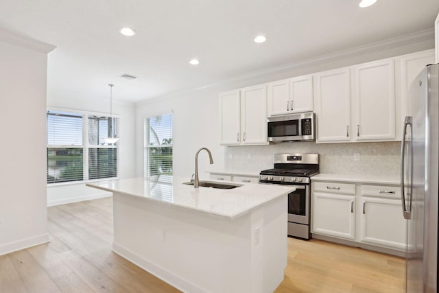 kitchen with white cabinetry, sink, an island with sink, and appliances with stainless steel finishes