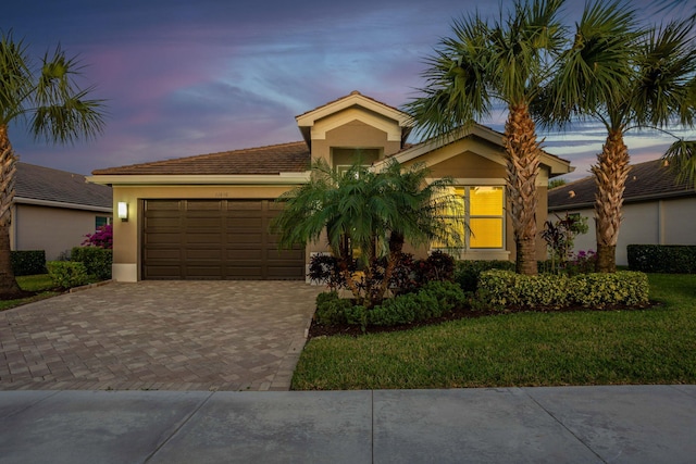 view of front of house with a yard and a garage