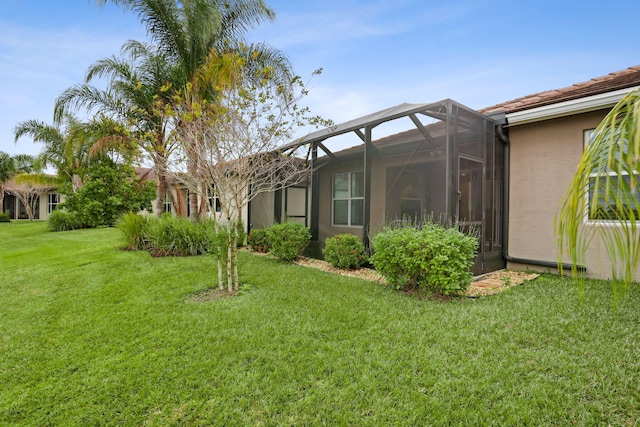 view of yard with glass enclosure