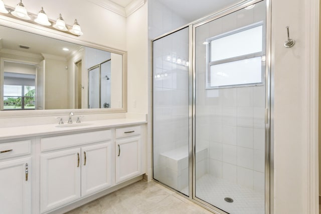 bathroom with vanity, a shower with door, and ornamental molding