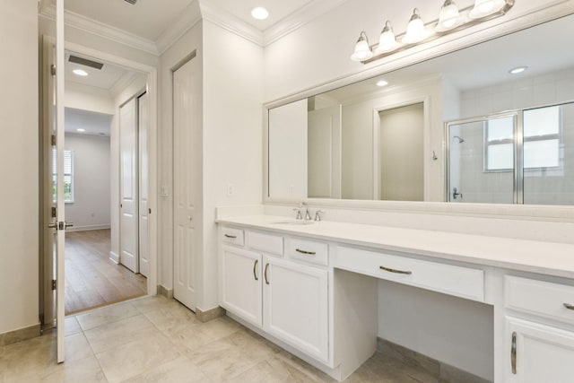 bathroom with vanity, tile patterned floors, an enclosed shower, and ornamental molding