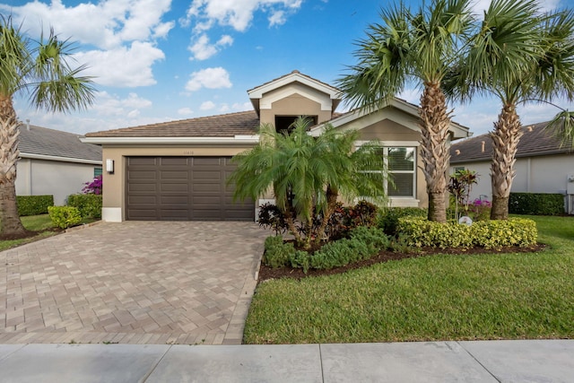 view of front of home with a front lawn and a garage