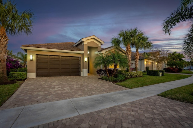 view of front facade featuring a garage and a yard