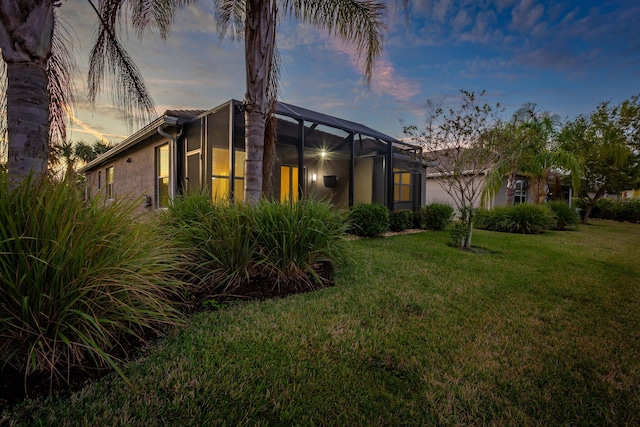 exterior space with a yard and glass enclosure