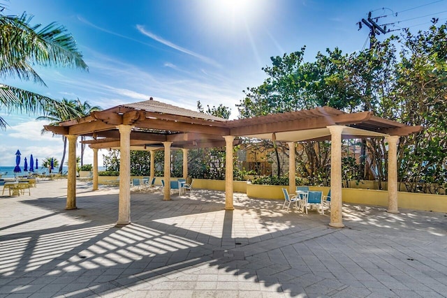 view of property's community featuring a patio area and a pergola