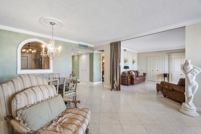 living room with crown molding, light tile patterned floors, a textured ceiling, and an inviting chandelier