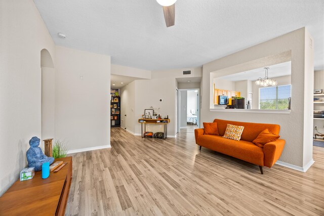 kitchen featuring appliances with stainless steel finishes, light wood-type flooring, and hanging light fixtures