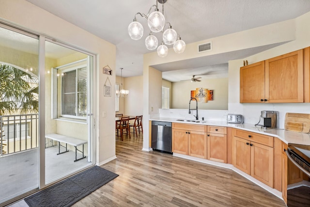 kitchen with ceiling fan with notable chandelier, sink, light hardwood / wood-style flooring, dishwasher, and hanging light fixtures