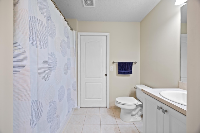 bathroom with vanity, tile patterned floors, toilet, and a textured ceiling