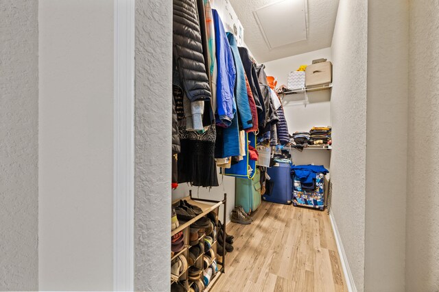 bedroom featuring a textured ceiling, a closet, ceiling fan, and hardwood / wood-style flooring