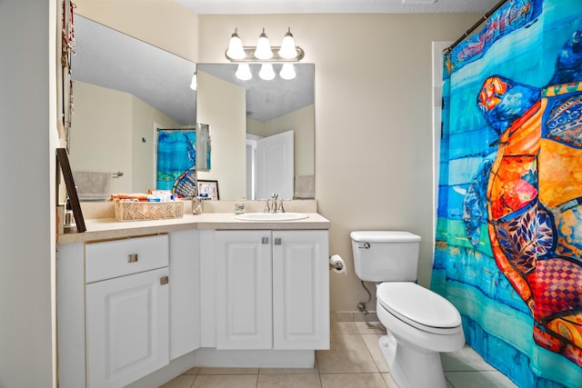 bathroom with tile patterned flooring, vanity, toilet, and walk in shower