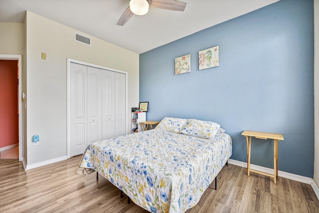 bedroom with hardwood / wood-style flooring, a closet, and ceiling fan