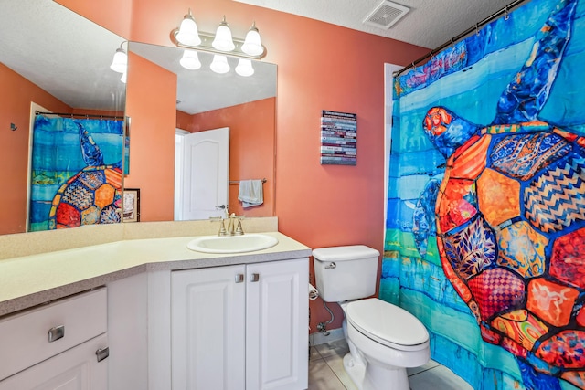 bathroom featuring vanity, a shower with curtain, tile patterned flooring, toilet, and a textured ceiling