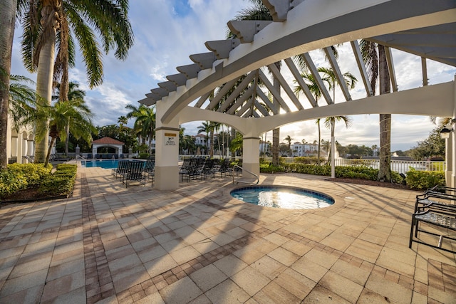 view of swimming pool featuring a gazebo, a community hot tub, and a patio