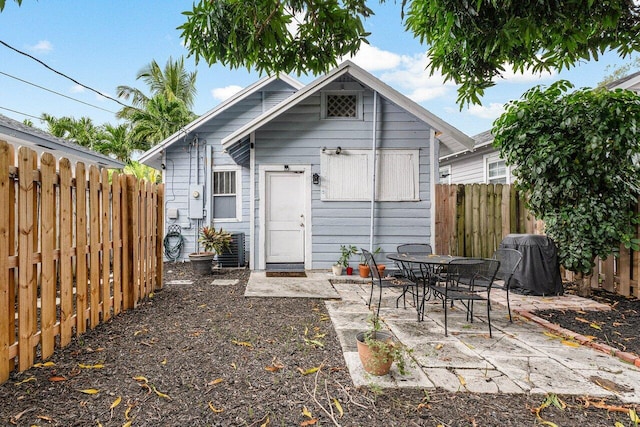 back of house featuring a patio and an outdoor structure