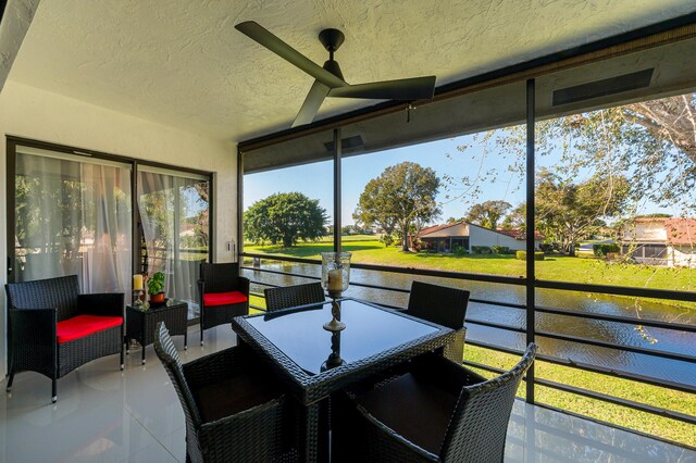 sunroom / solarium with a water view