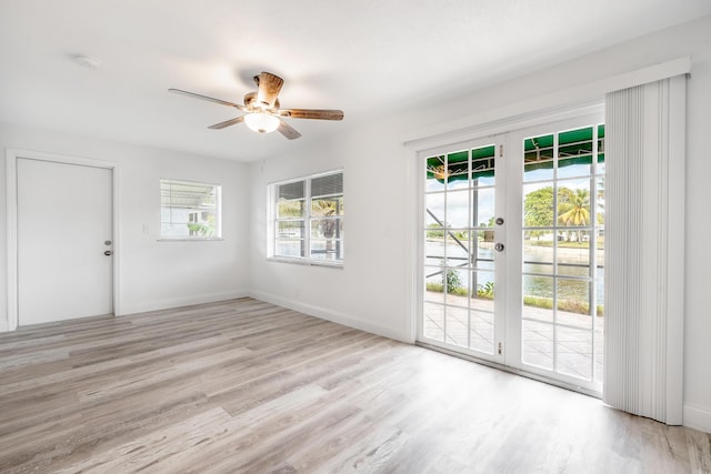 empty room featuring light wood-type flooring and ceiling fan