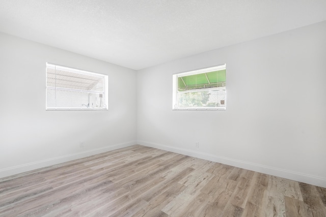 unfurnished room with light wood-type flooring