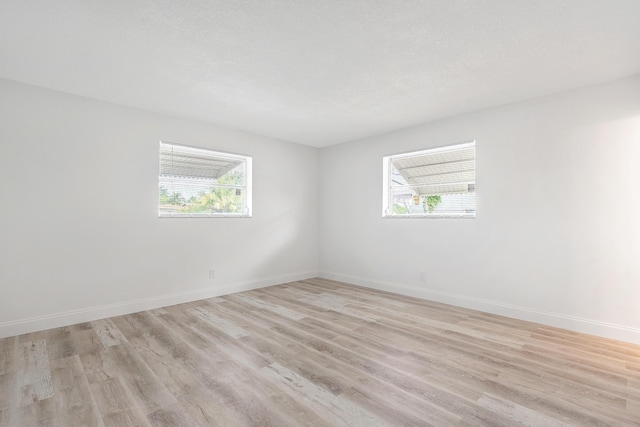 empty room with light hardwood / wood-style floors