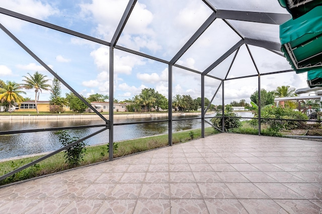 view of patio / terrace with a water view and glass enclosure