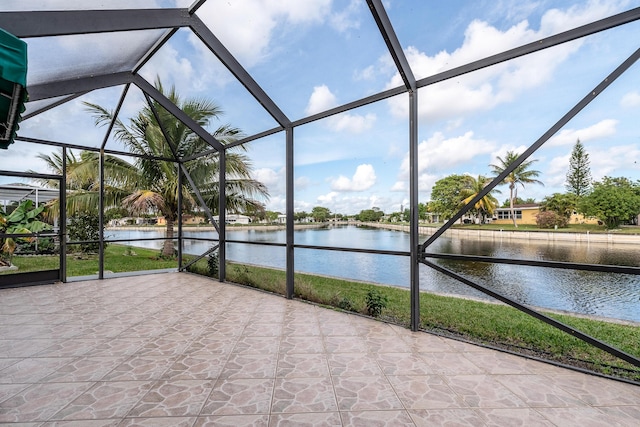 unfurnished sunroom featuring a water view