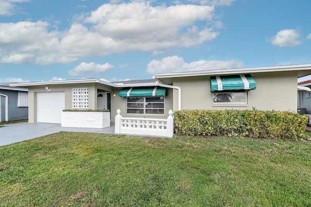 ranch-style house with a garage and a front lawn