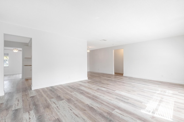 empty room with light wood-type flooring and ceiling fan