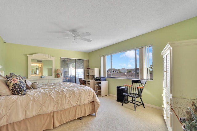 bedroom with light carpet, a textured ceiling, and ceiling fan