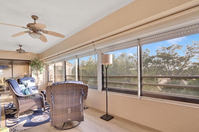 sunroom / solarium featuring ceiling fan