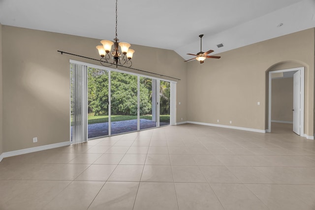 empty room featuring vaulted ceiling, light tile patterned floors, ceiling fan with notable chandelier, and arched walkways