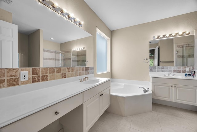 full bath featuring a stall shower, a garden tub, and a sink