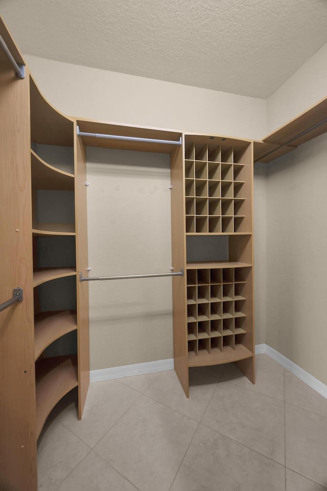 walk in closet with tile patterned floors