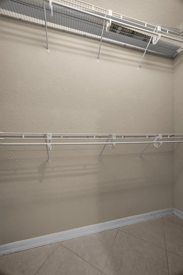 spacious closet featuring tile patterned floors