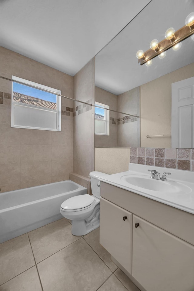 full bath featuring vanity, tile patterned floors, toilet, and shower / washtub combination