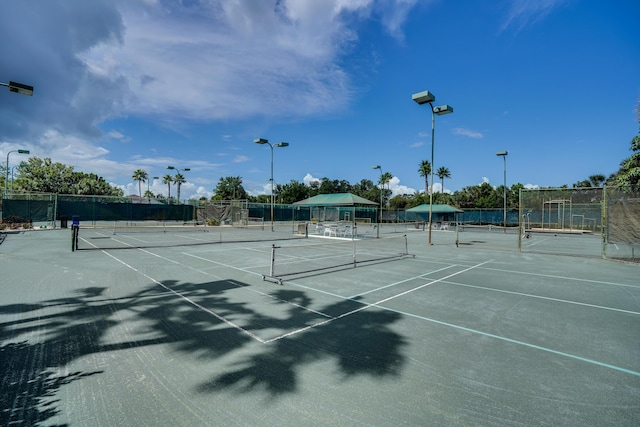 view of tennis court featuring fence