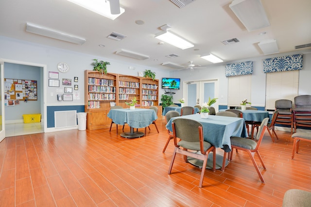 dining area with visible vents and wood finished floors