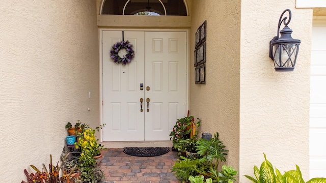 entrance to property featuring stucco siding