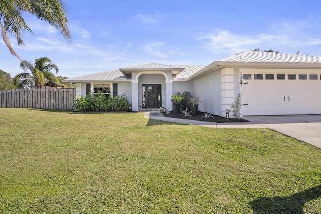 single story home with a garage and a front lawn