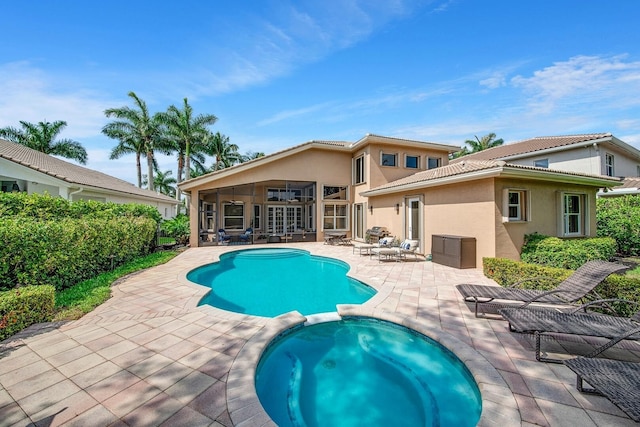 view of swimming pool featuring an in ground hot tub and a patio area