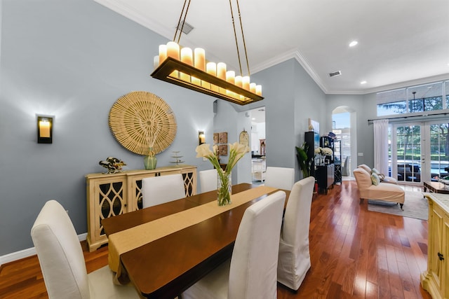 dining area featuring crown molding, french doors, and dark wood-type flooring