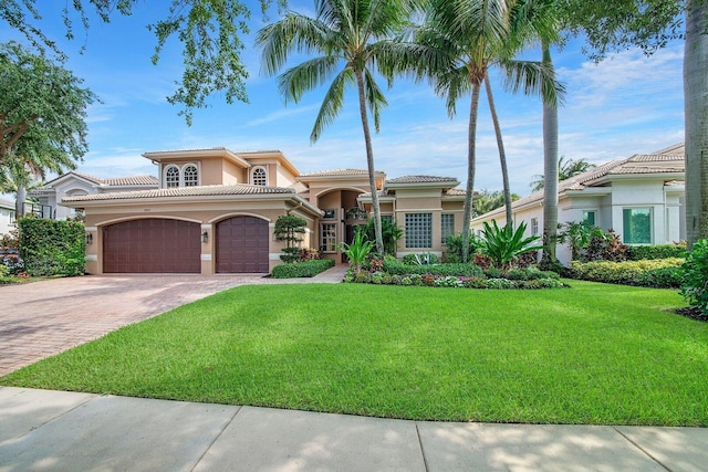 mediterranean / spanish-style house with a front yard and a garage