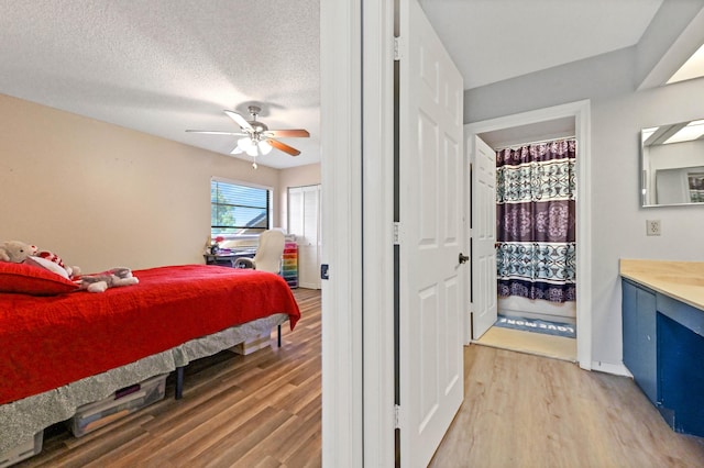 bedroom featuring hardwood / wood-style floors, a textured ceiling, and ceiling fan