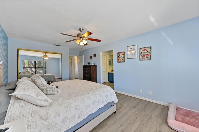 bedroom with ceiling fan and wood-type flooring