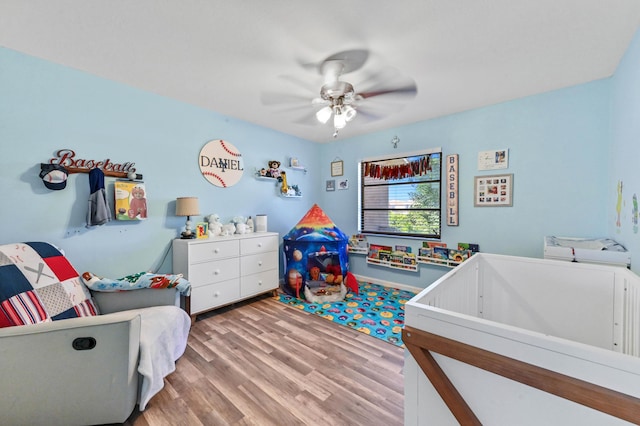 bedroom with light hardwood / wood-style flooring and ceiling fan