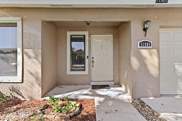 view of exterior entry with a garage